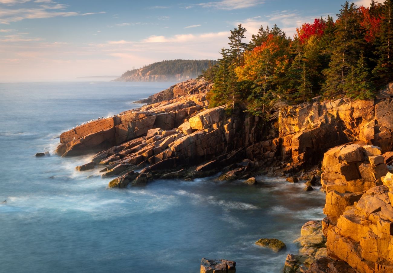 Fall foliage can be seen amongst the trees along the Canada New England coast.