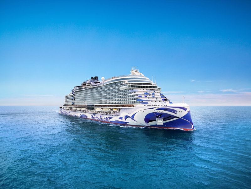 Norwegian cruise ship at port with palm trees and clear blue water